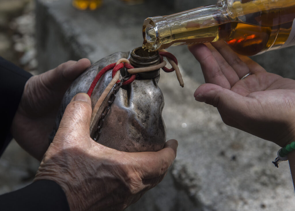 The Blackened Canteen is filled with bourbon during a B-29 Memorial Ceremony at Shizuoka City, Japan