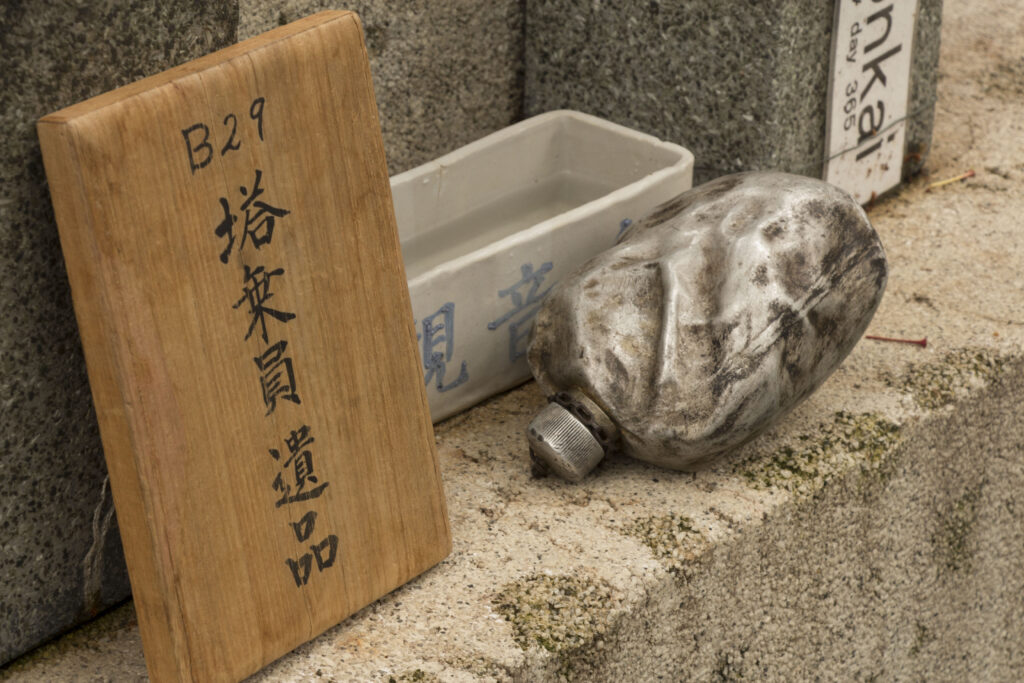 Blackened canteen rests on a shrine dedicated to the B-29 collision aircrew victims at the memorial ceremony in Shizuoka, Japan, Every year, U.S. and Japanese service members hike to the Sengen Hill monument in honor of those who lost their lives on June 20, 1945.